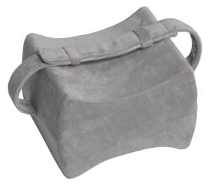 Gray memory foam knee pillow with strap for ergonomic home care and mobility sleep support.