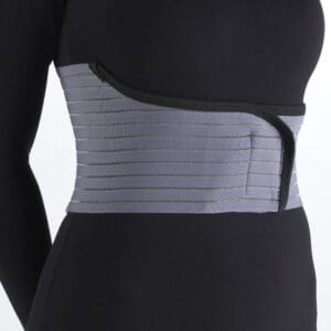 Woman wears gray OTC Select Series 6" Rib Belt for rib support, home care, mobility aid.