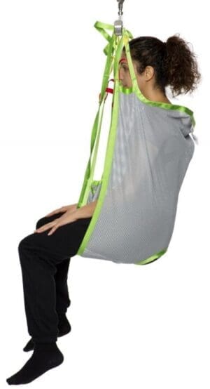 HumanCare Low Basic Sling with green straps in use for assisted transfer, home care mobility support.