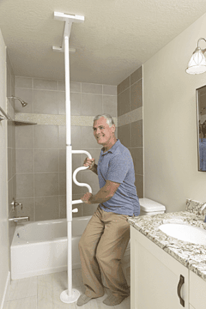 Older man uses Stander Security Pole & Curve Grab Bar 1100 for bathroom mobility support.