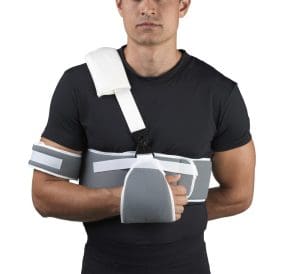 OTC Sling & Swathe Shoulder Immobilizer 2465 supports left arm for home medical care.