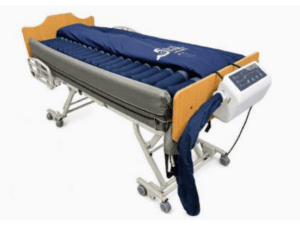 Permobil Aries Lateral Rotation hospital bed with air mattress for home care pressure relief.