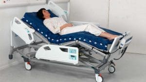 Arjo Nimbus medical air mattress on hospital bed for pressure relief and home care support.