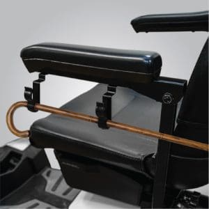 Mobility chair with cane clip attachment securely holding walking cane for home care support.
