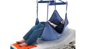 Arjo Bariatric Loop Hammock Sling (MAA8030) on overhead lift supports patient transfer in home care.