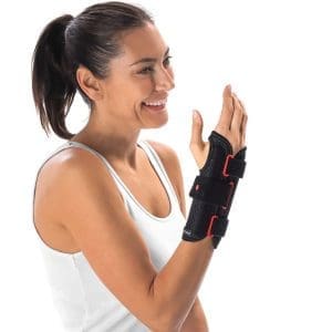 Woman wears DonJoy RespiForm+ Wrist-Thumb Brace for home care and wrist support.