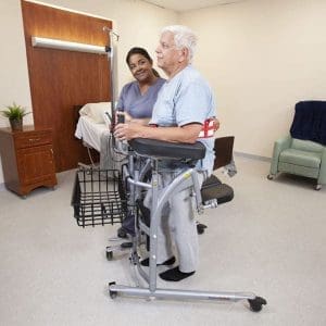 Standing mobility aid for seniors, hospital use; healthcare worker assists with patient mobility support.